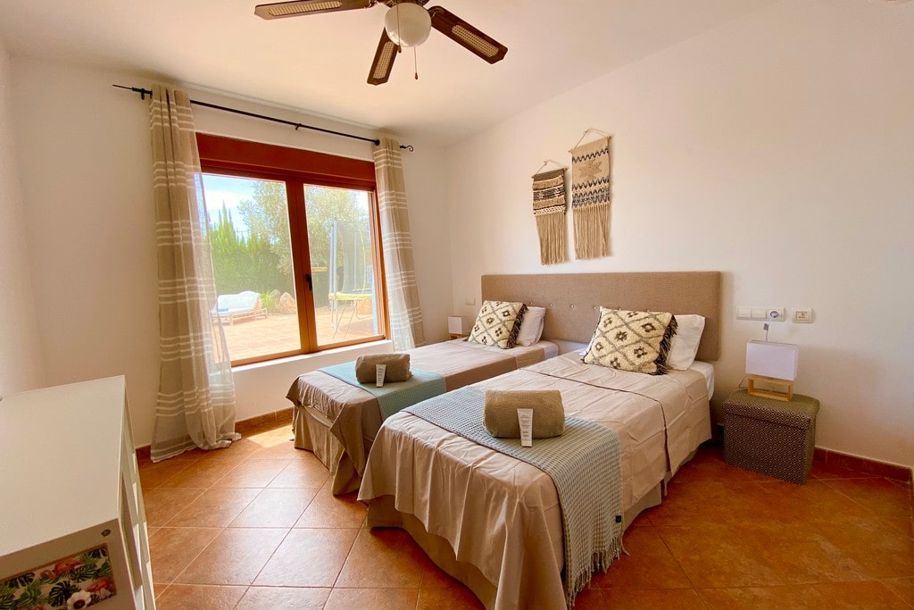 BEDROOM 2 : The en-suite bathroom features a shower, large basin and WC with modern furnishing. BEDROOM 2 – Located on the ground floor. Twin beds with AC and bathroom with shower, sink & WC. (This bathroom is also the guest bathroom)